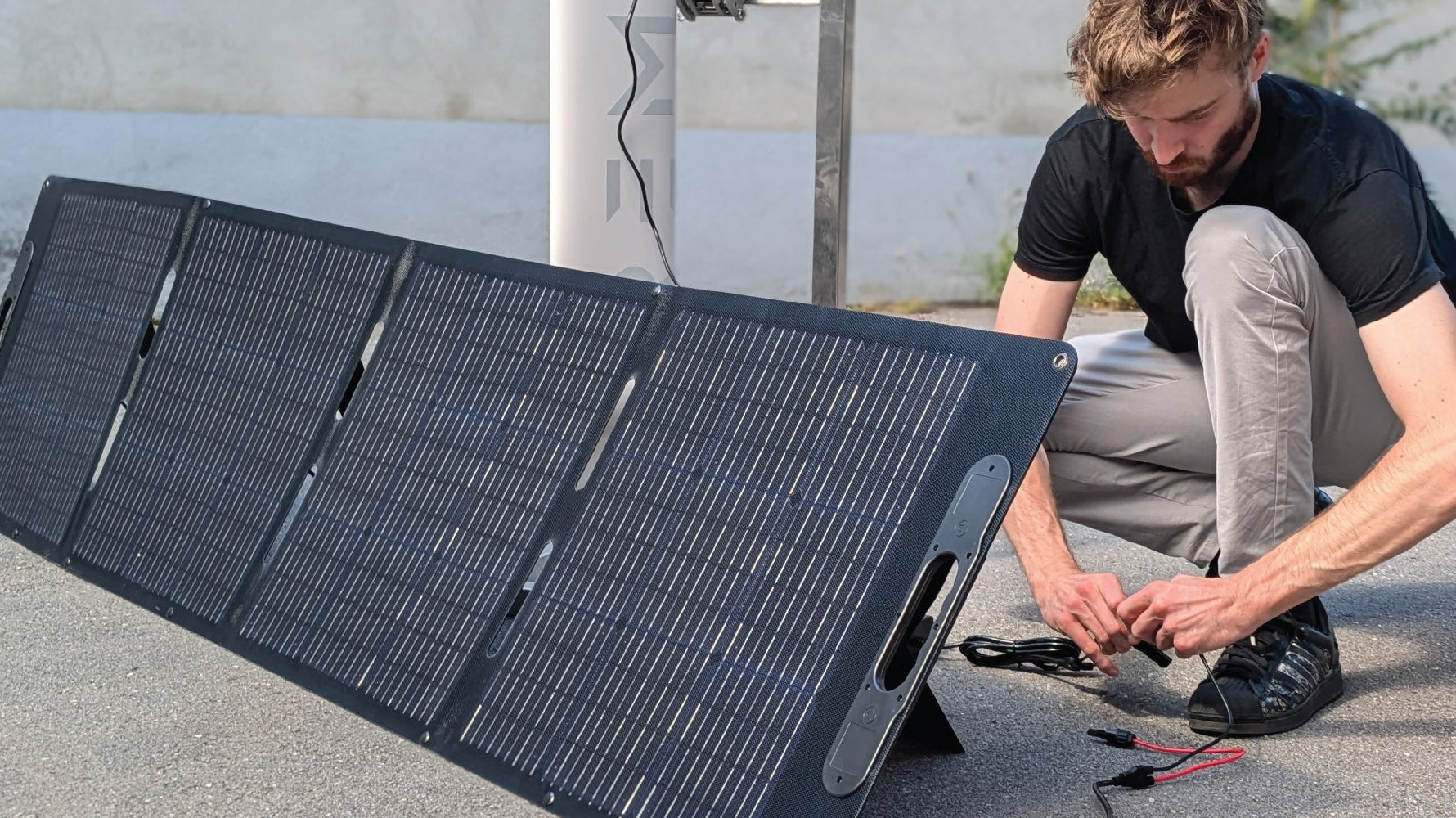 Man is setting up the solar charging for RREMIGO