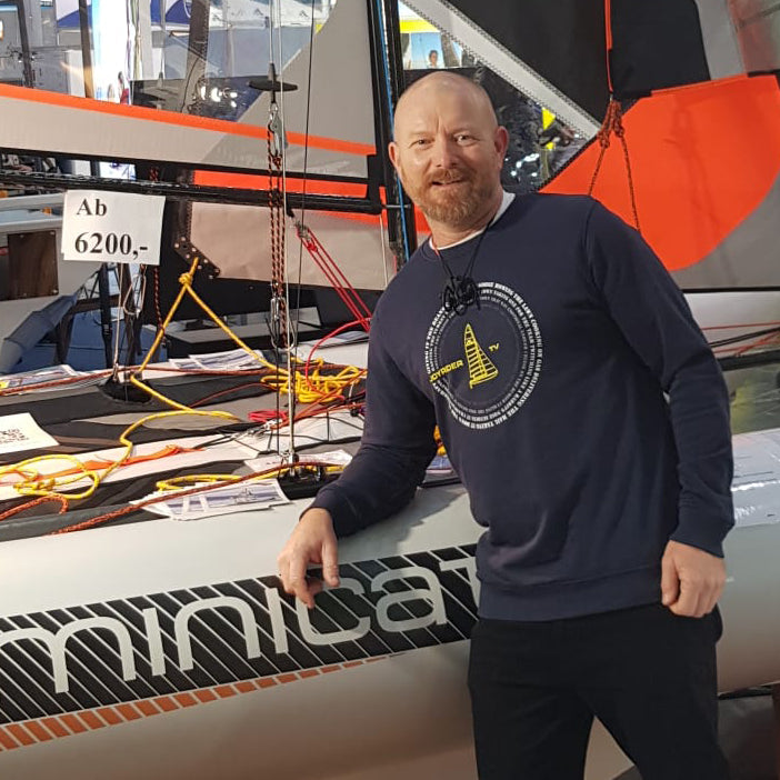 Joe Bennet, the ambassador of MiniCat at the exhibition next to MiniCat