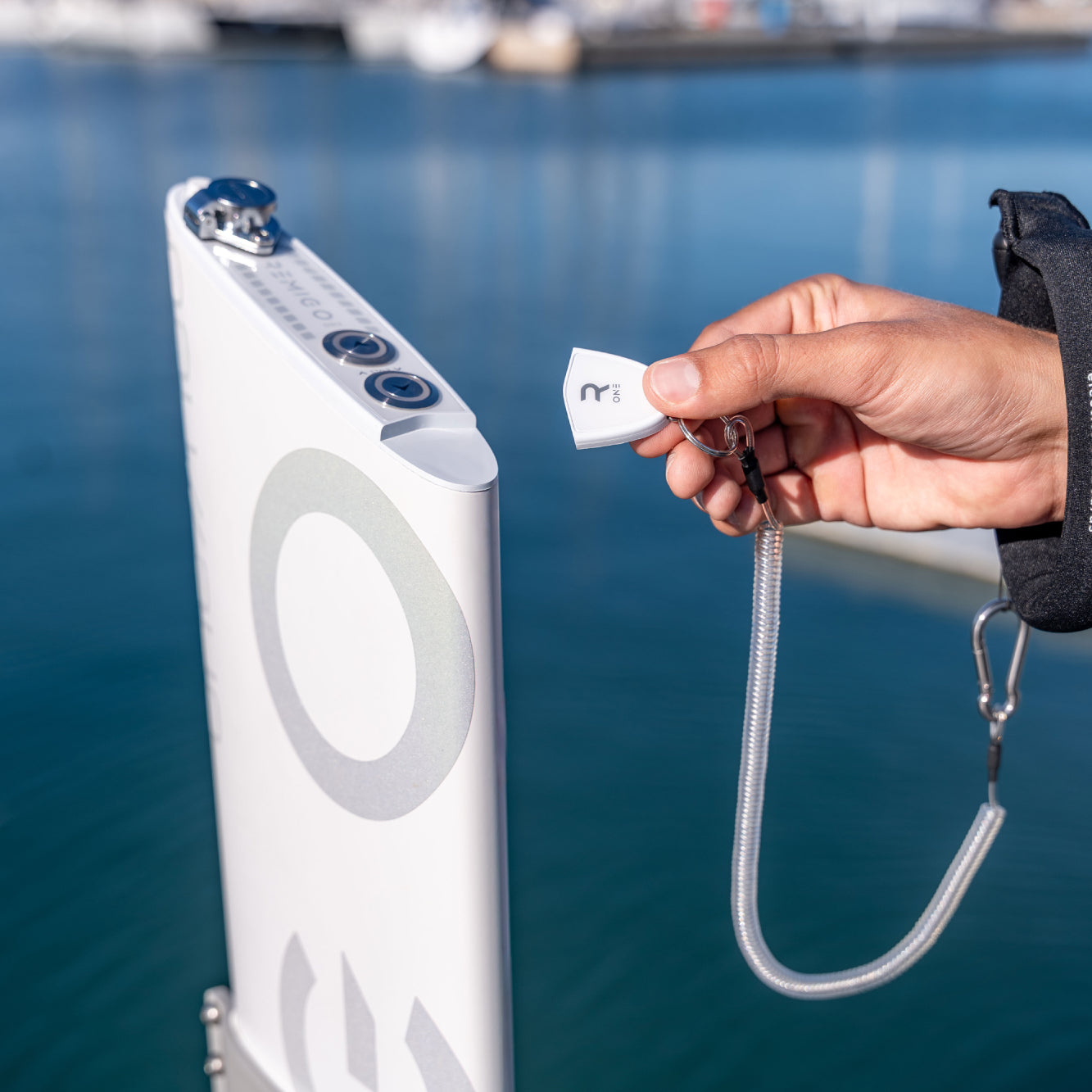 Person holding a key for remigo electric outboard