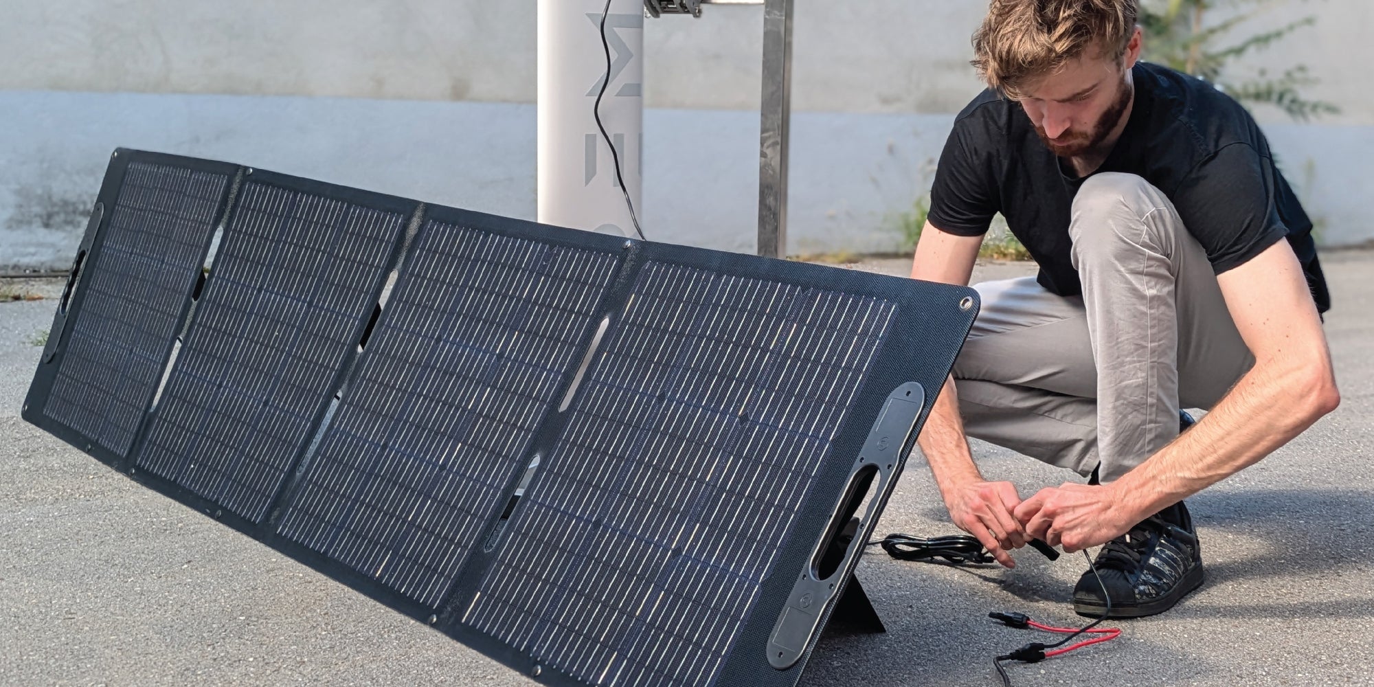 Man is setting up the solar charging for RREMIGO