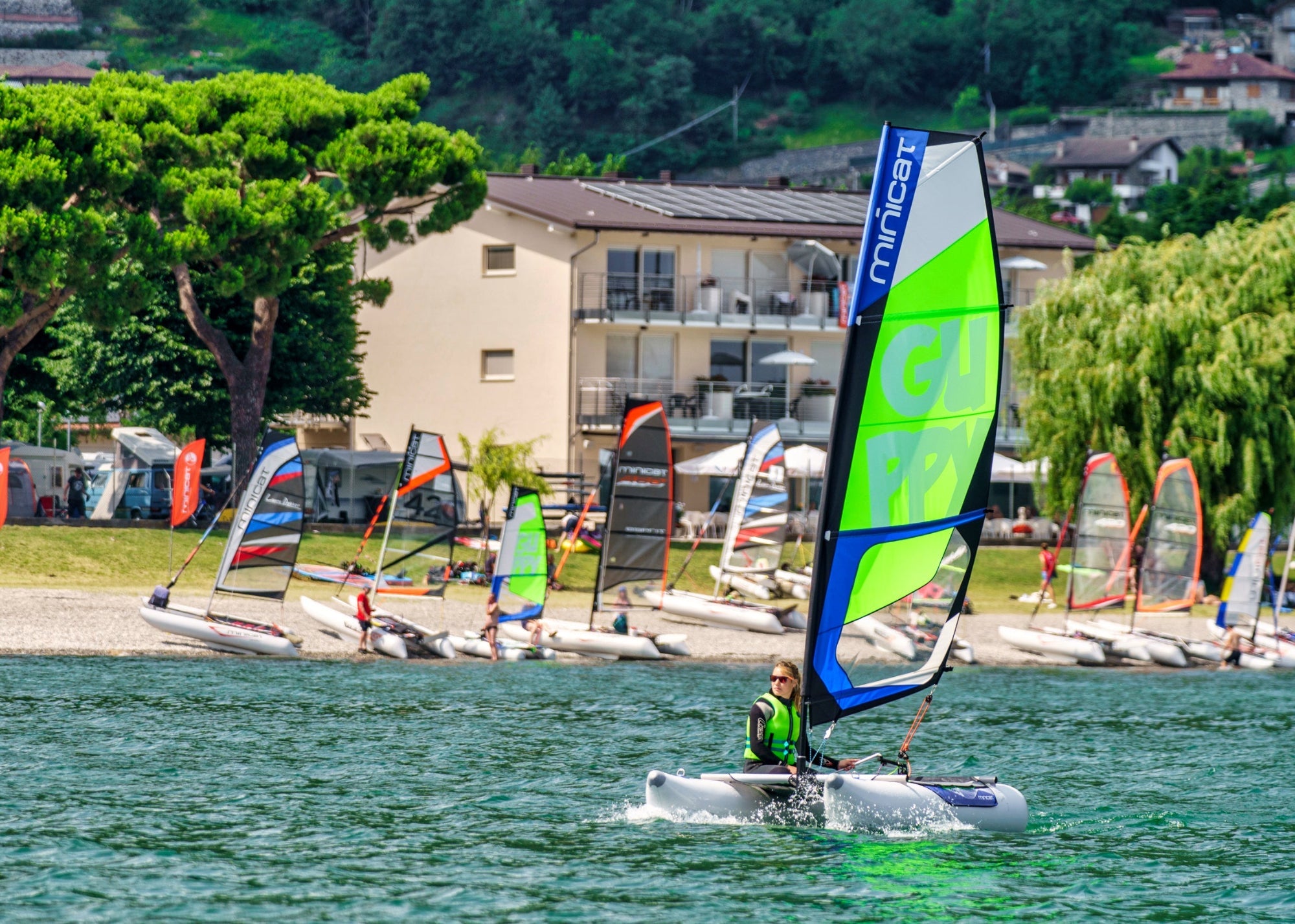 MiniCat Guppy inflatable sailing catamaran at regatta