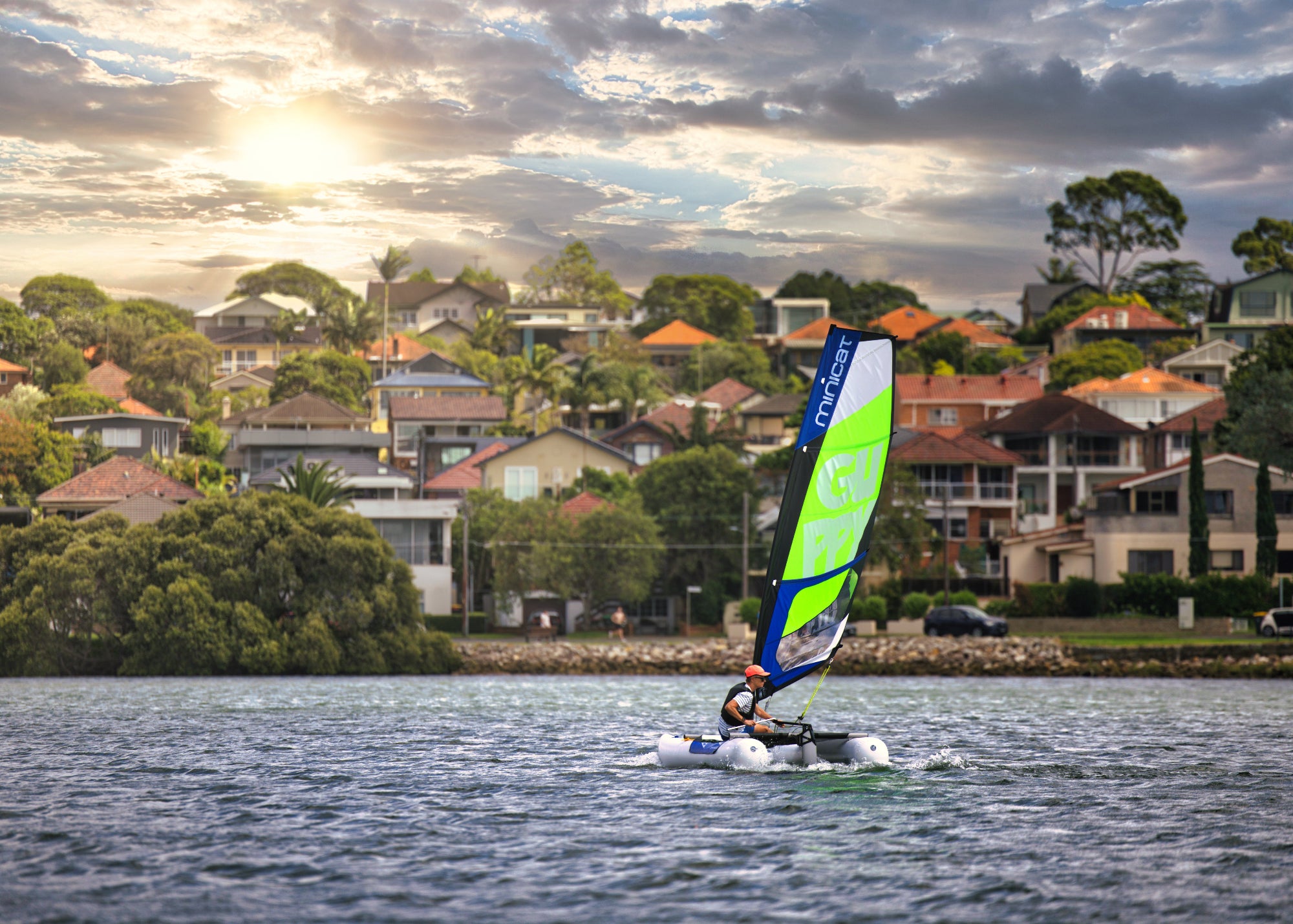Sailboat MiniCat Guppy sailing in a bay in Sydney Australia 