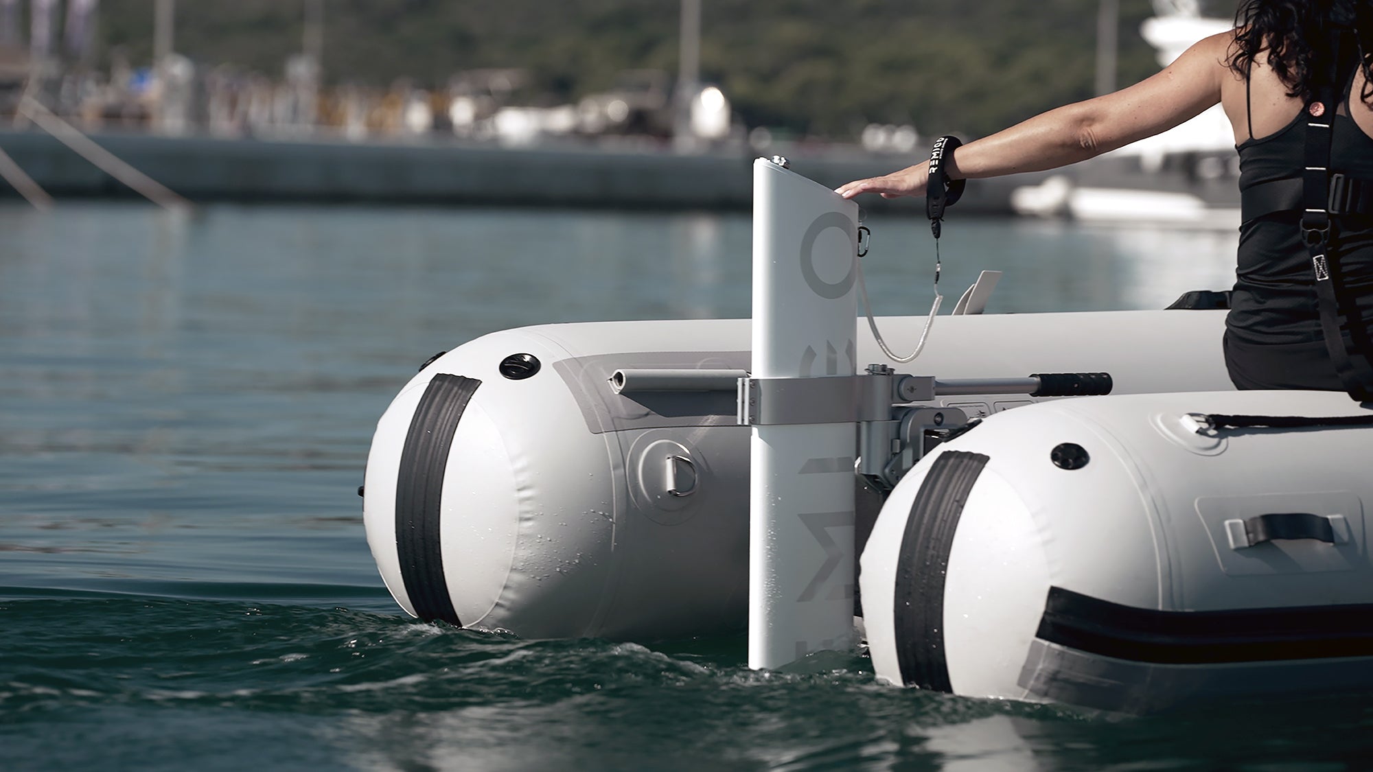 Inflatable boat with a person holding REMIGO electric engine