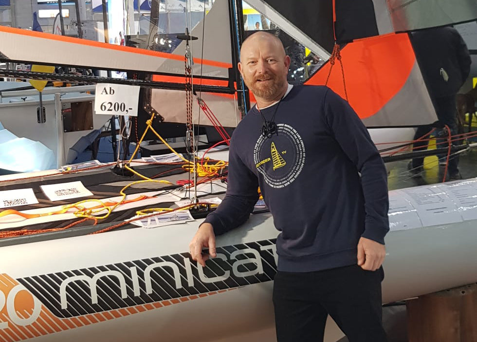 Joe Bennet, the ambassador of MiniCat at the exhibition next to MiniCat