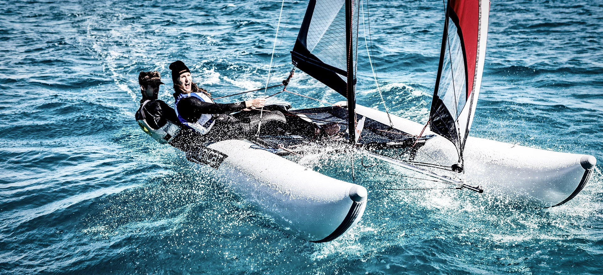 Two people sailing MiniCat in the ocean