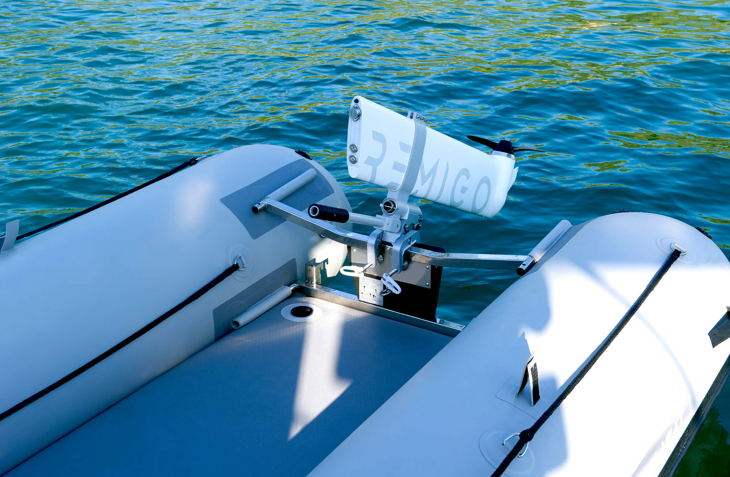 White inflatable boat with a motor on a body of water