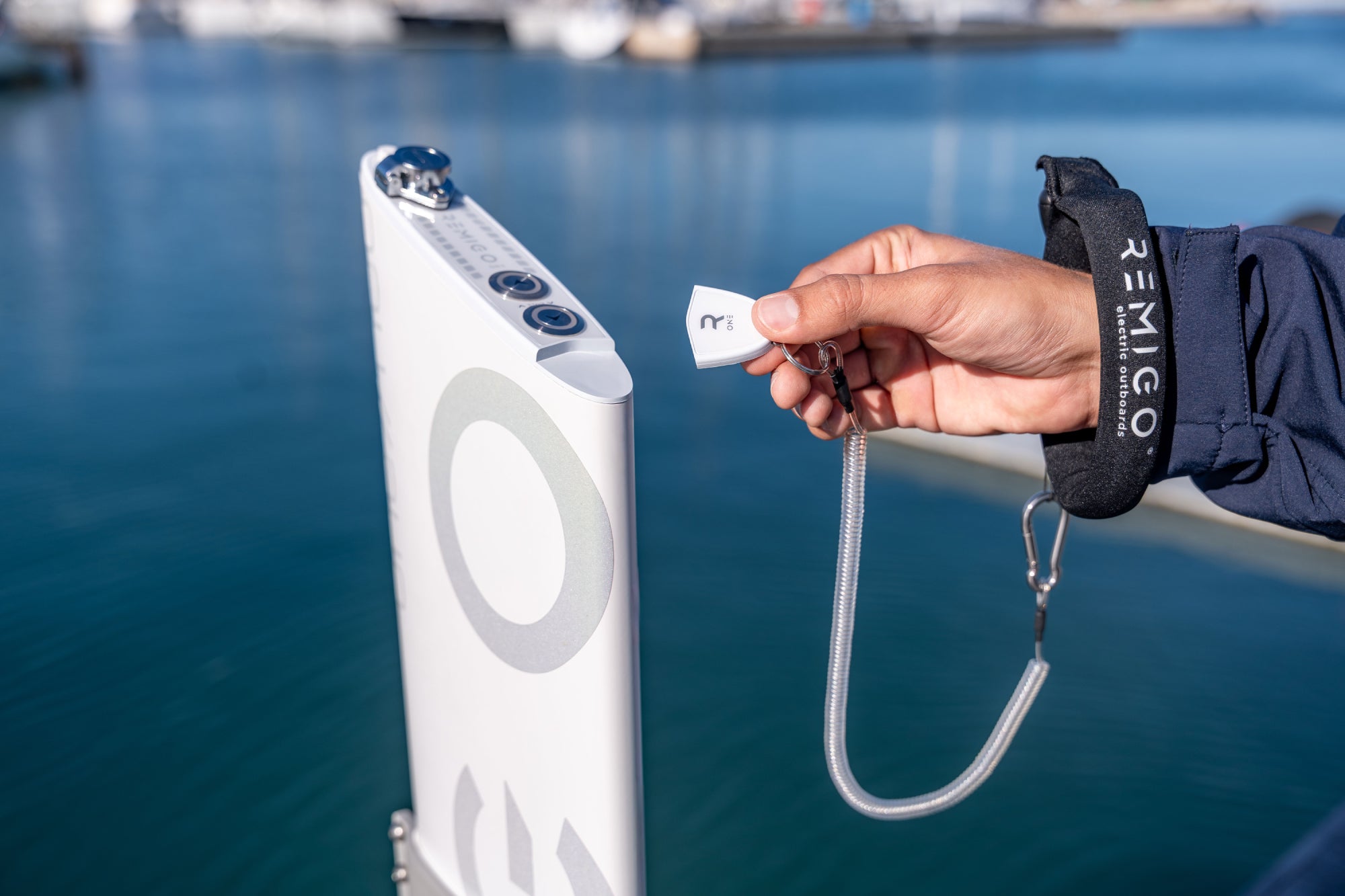 Person holding a key for remigo electric outboard