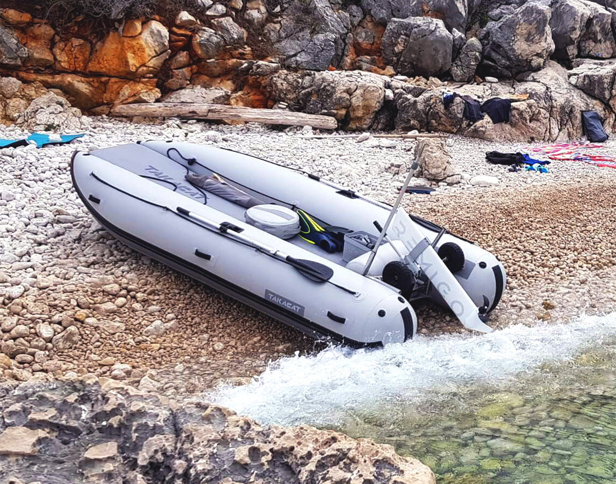 Inflatable boat takacat on a rocky beach with water nearby

Details